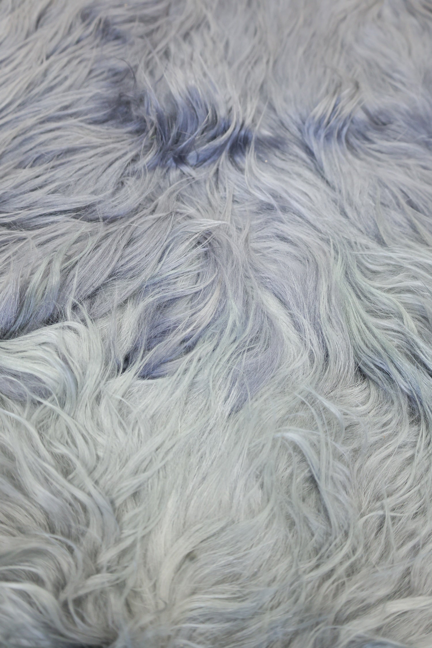 Soft, ombre gray animal hide rug texture.
