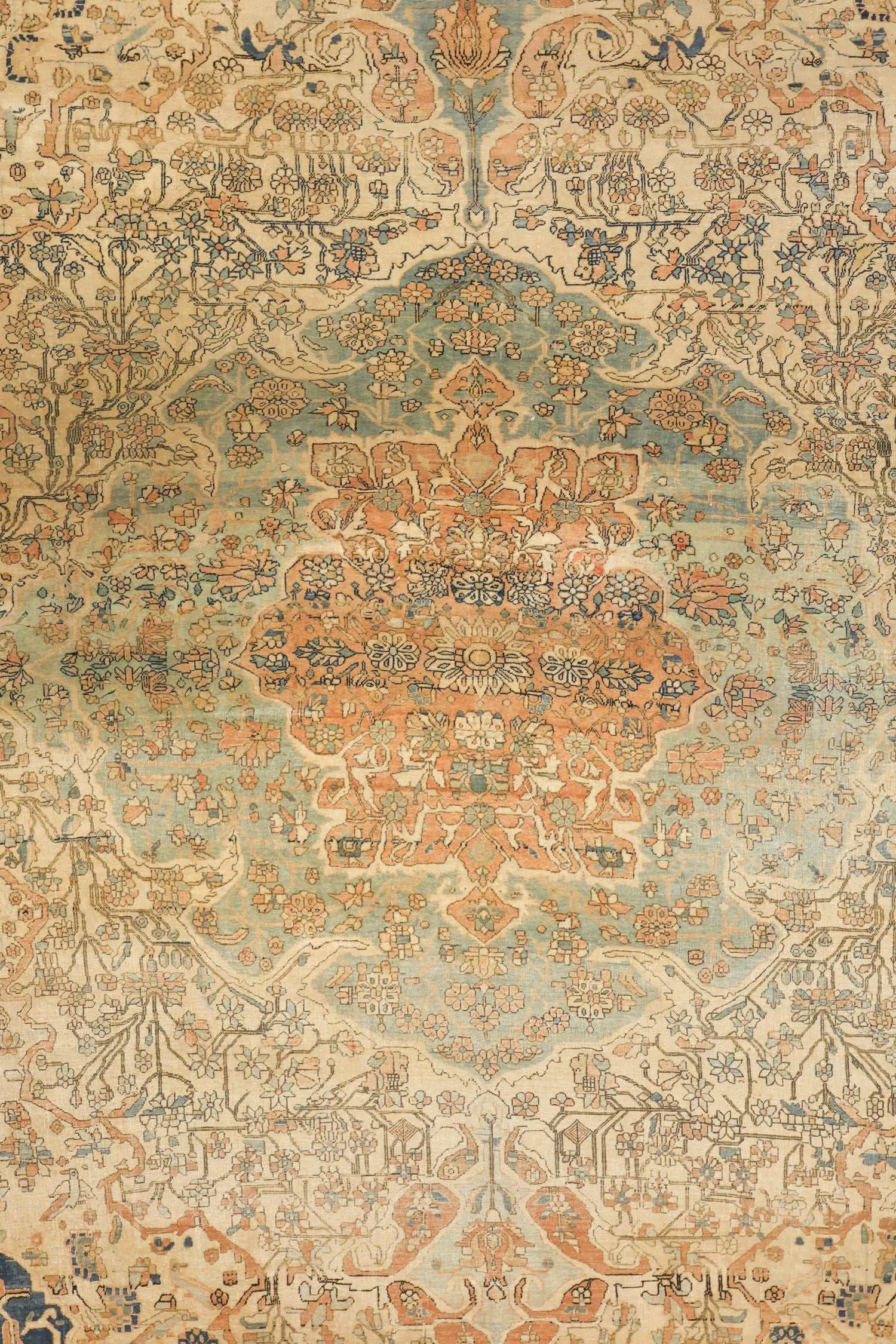 Detail of antique Kashan rug, featuring a traditional floral and vine pattern in muted pinks, blues, and beige.
