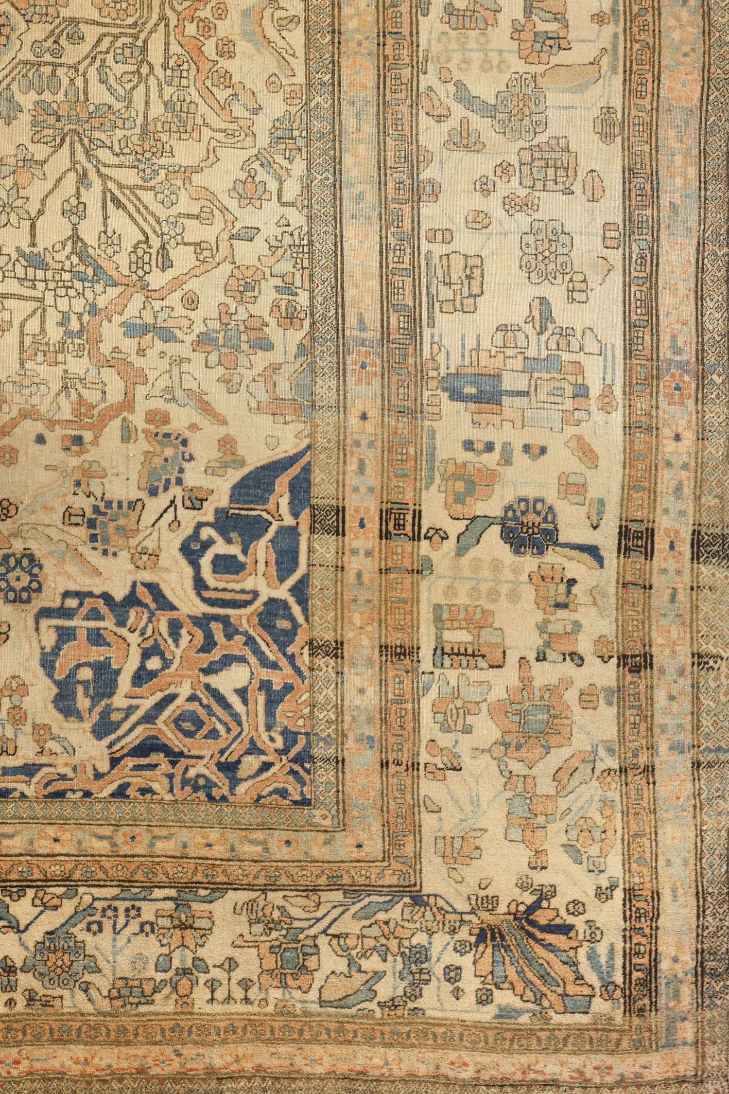 Detail of antique Kashan rug, showcasing handwoven floral and geometric patterns in muted blues and beige.
