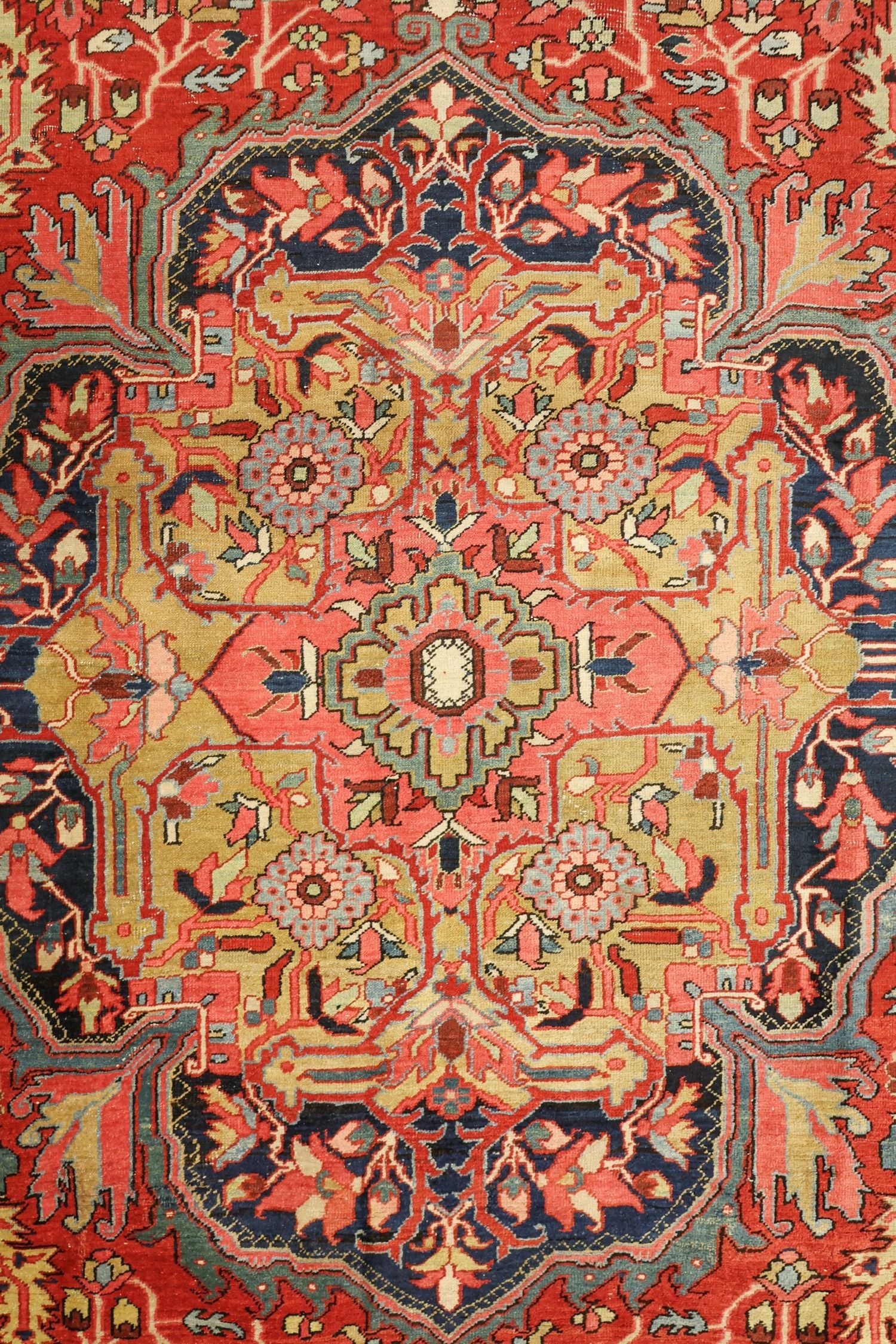 Intricate handwoven rug detail; vibrant reds, blues, and golds in a traditional tribal design.
